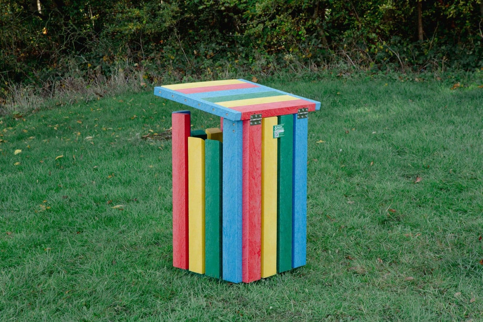 Waste Bin Rainbow 2 - Marmax Recycled Plastic Products - Manufactured in the UK Rainbow Waste Bin with open lid on grass